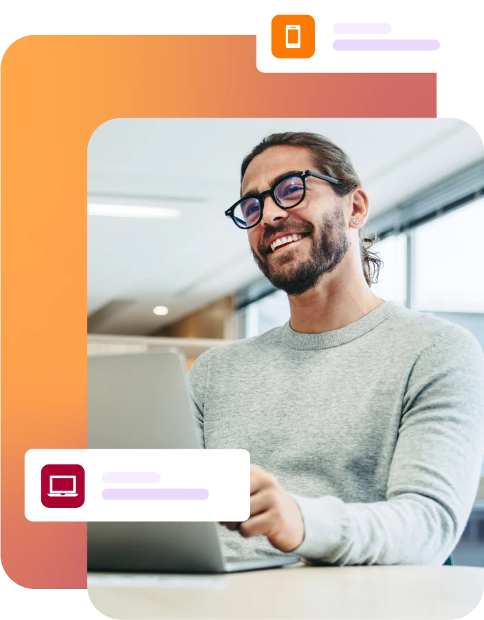 Smiling man with laptop on desk